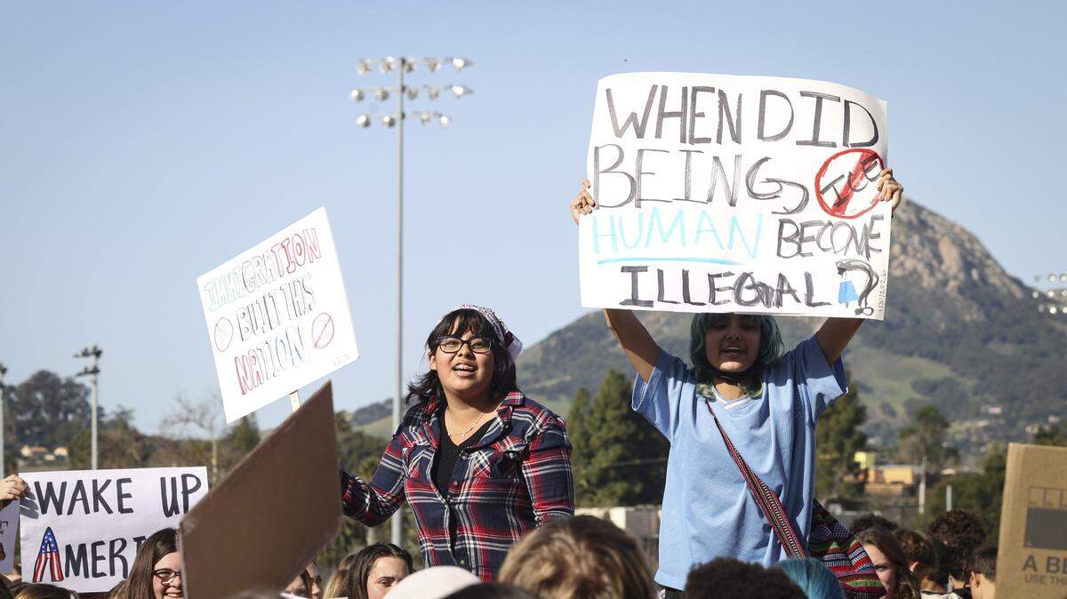 Melisa Tapia, left and Exander Luna held signs and spoke to the crowd. About 200 San Luis Obispo High School students filled the quad as part of a national day of protest against ICE on Jan. 30, 2026.