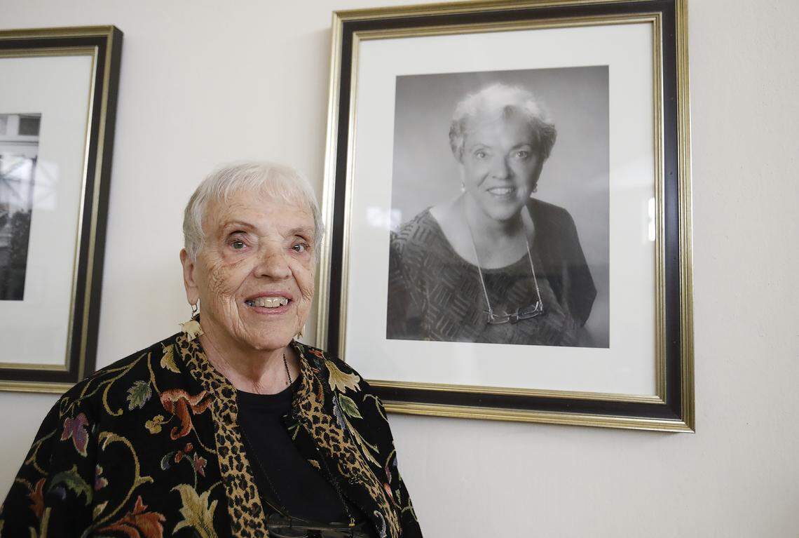 Eleanor Shumway, guardian-in-chief of the Temple of the People in Halcyon, stands in front of her portrait hanging inside the temple.