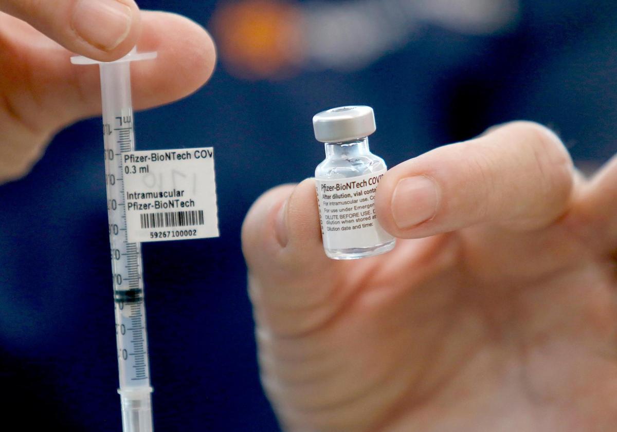 A healthcare workers holds a bottle and syringe of the Pfizer coronavirus vaccine at French Hospital Medical Center’s clinic. The Pfizer shot is the only one that’s FDA-approved for use in children and teens ages 12 to 17.