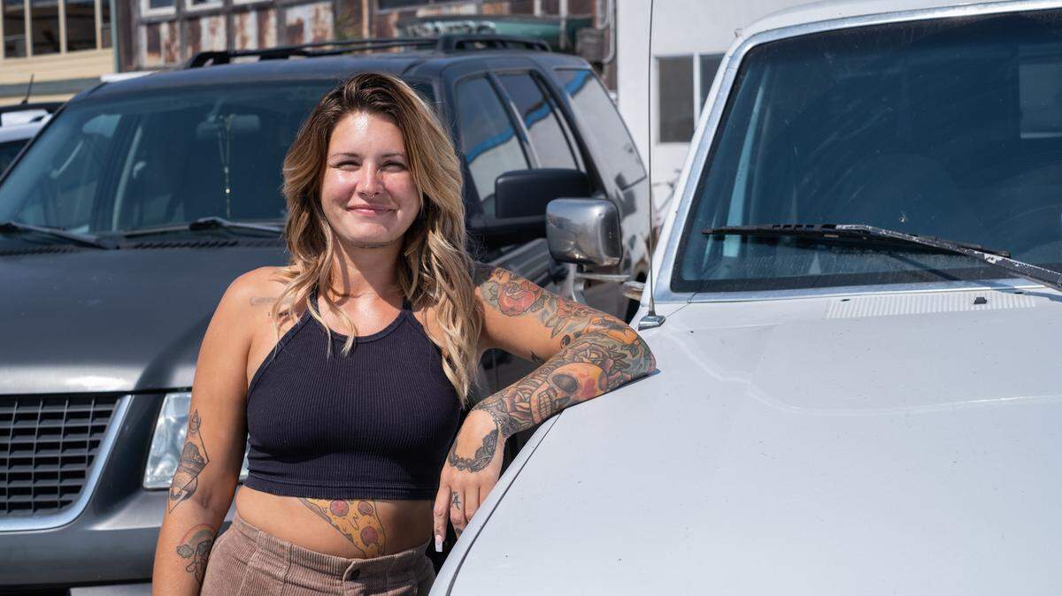 Former Cal Fire employee Carrie Young, here with her dog Mary J. and truck, which used to be her home, in Cayucos on Sept. 21, 2023, settled a lawsuit with Cal Fire after she was sexually assaulted by James Thomas, a coworker, in 2020. Thomas was convicted of sexual battery in relation to the incident in May 2023.