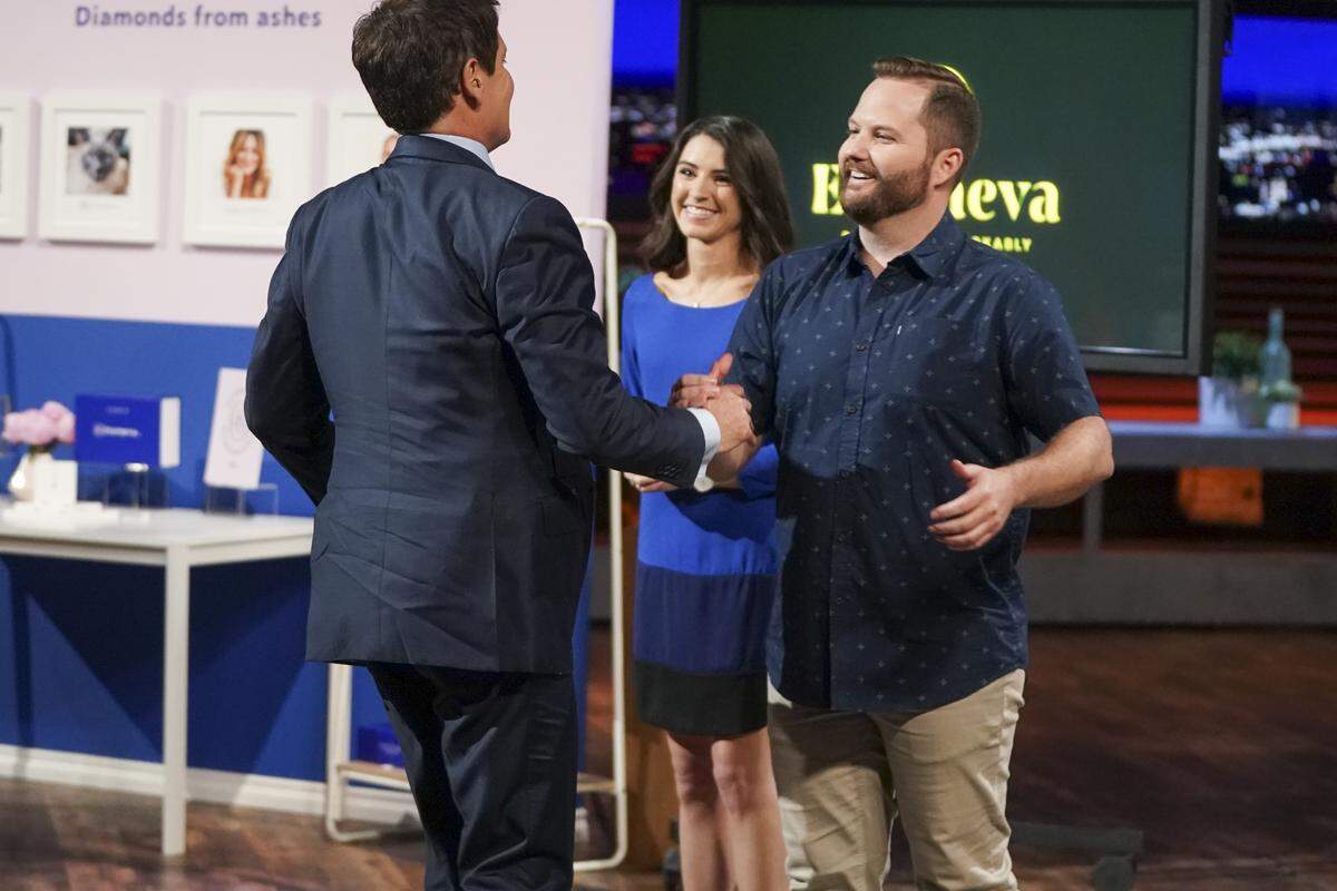 Eterneva co-founders Adelle Archer, center, and Garrett Ozar, right, shake hands with investor Mark Cuban on an episode of “Shark Tank” on Sunday, Oct. 13, 2019.