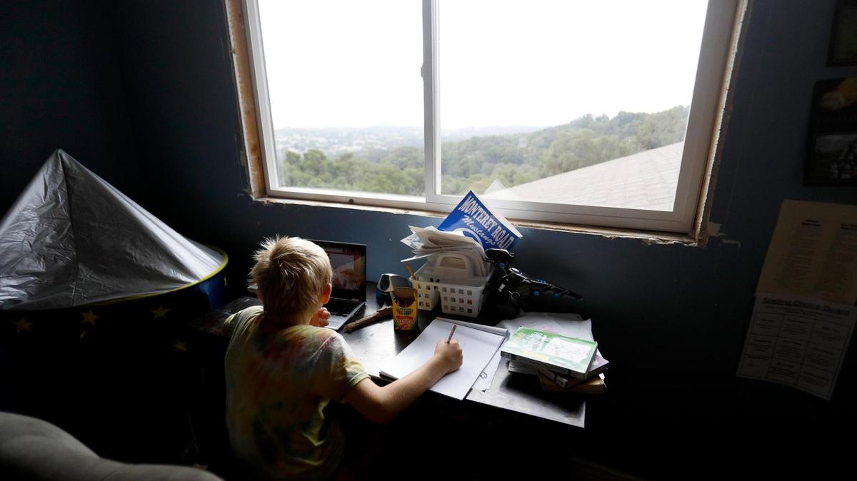 Nolan Keiper, 8, has a sweeping view of Atascadero from his bedroom window as he listens to his lessons.. He is distance learning with the Atascadero Unified School District.