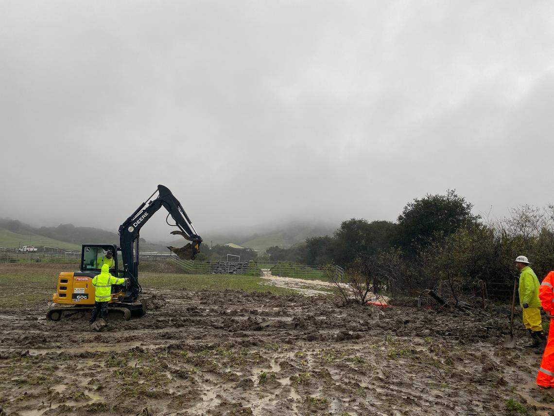 Workers try to divert water away from Cal Poly in San Luis Obispo in Monday, Jan. 9, 2023.