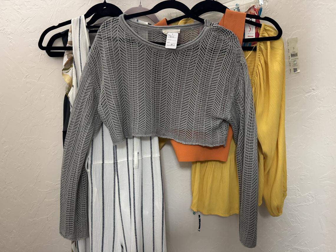 A gray May Berries sweater and other clothes from Lumina Thrift in San Luis Obispo on April 16, 2026.