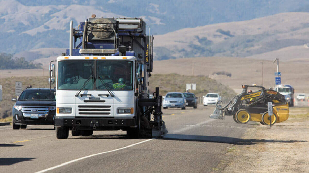 Workers using heavy equipment grind stripes off the road Tuesday, Oct. 15, on Highway 1 north of San Simeon Acres.