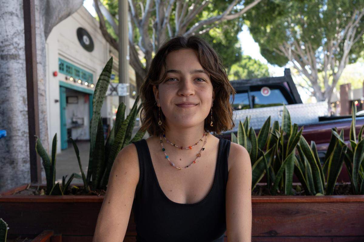 Maddie Kelly, 22, poses for a portrait in downtown San Luis Obispo on May 3, 2022. Kelly is a Cal Poly student studying women and gender studies. She said she was shocked and disgusted by the regression in reproductive rights that were described in the leaked SCOTUS opinion regarding the fate of Roe v. Wade.