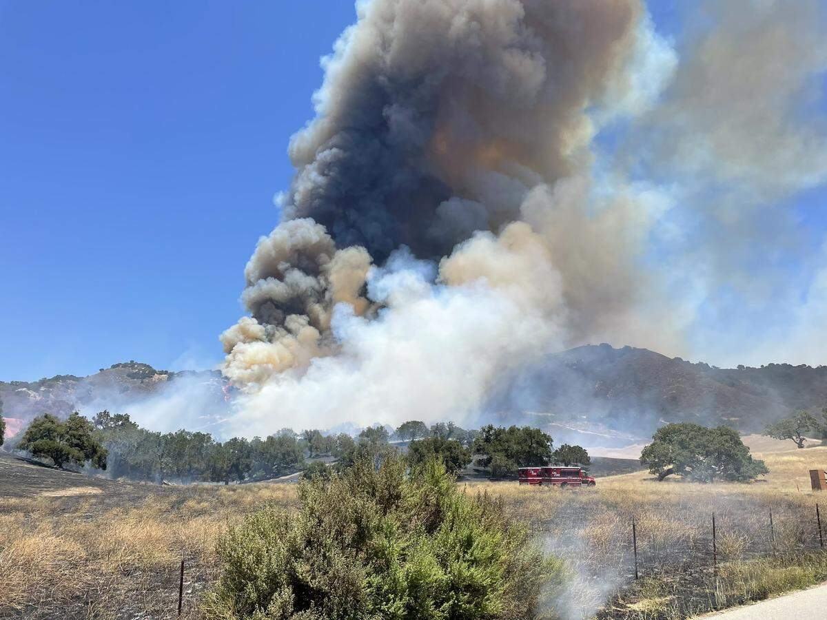 The Camino Fire sends up a column of smoke near the intersection of Huasna Road and Christine Loomis Drive on June 28, 2022.