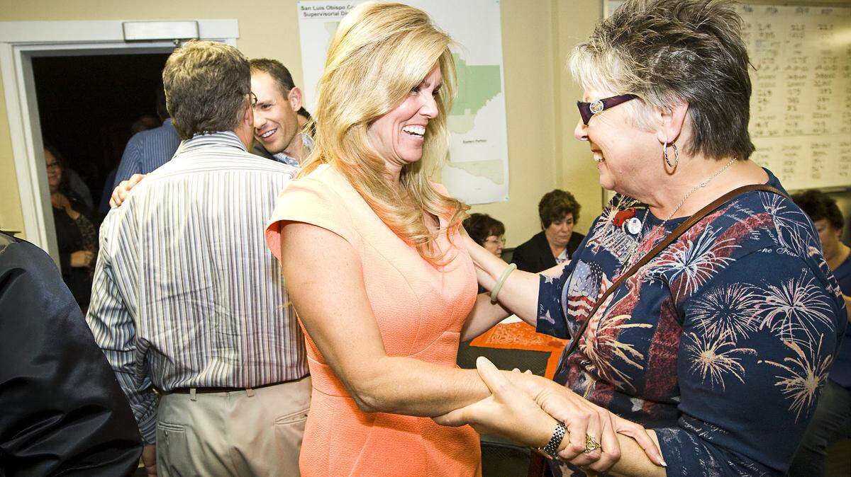 Lynn Compton talks with friend and supporter Linda Osty during an election-night party Tuesday at the Compton campaign headquarters.