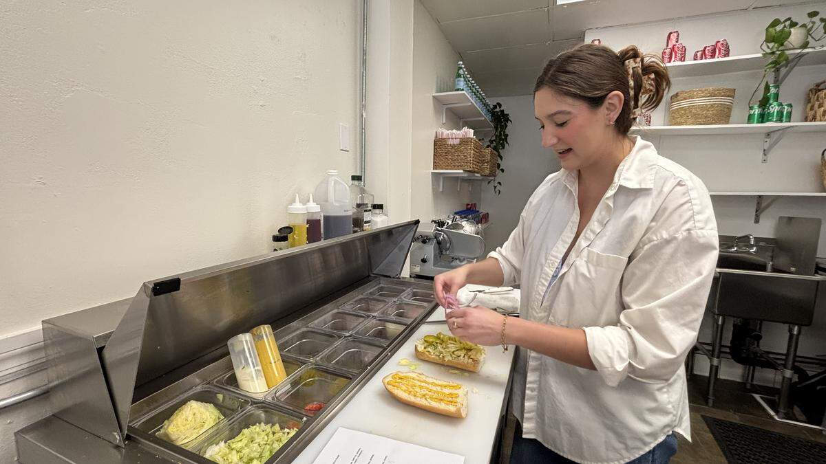 Geneva Franciskovich, owner of Swell Sandwich, makes a build-your-own sandwich order. The shop opened April 23 and serves cold cut sandwiches, chips and soda.