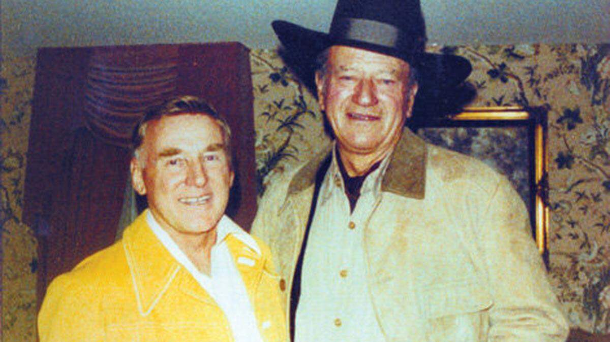 John Wayne, in hat, once teased Alex Madonna about his bald head and sent him this photo of the two of them, Madonna wearing a toupee. See more photos>>
