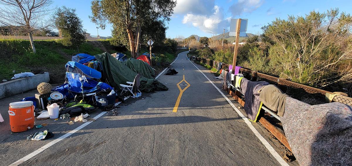 Belongings from homeless people line the Bob Jones Trail at Los Osos Valley Road in January 2023 after high water from storms made the area uninhabitable.