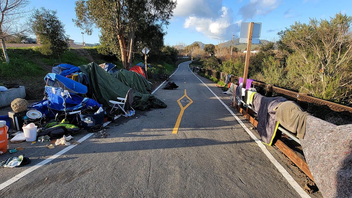 Belongings from homeless people line the Bob Jones Trail at Los Osos Valley Road in January 2023 after high water from storms made the area uninhabitable.