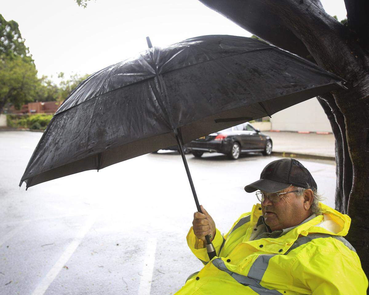 Jeremy Price was prepared for the weather as he monitors the parking lot for US Bank on Christmas Eve, Dec. 24, 2025, in downtown San Luis Obispo.