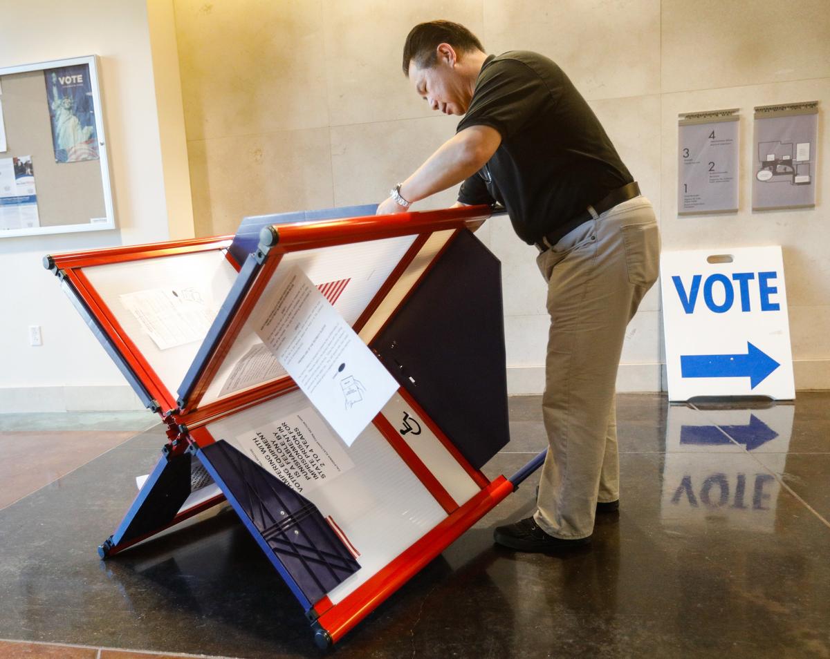 San Luis Obispo County Clerk-Recorder Tommy Gong dismantles a portable voting station Wednesday in the lobby of the county offices. Valid ballots are still arriving by mail, and the County Clerk-Recorder’s office is working to process them.
