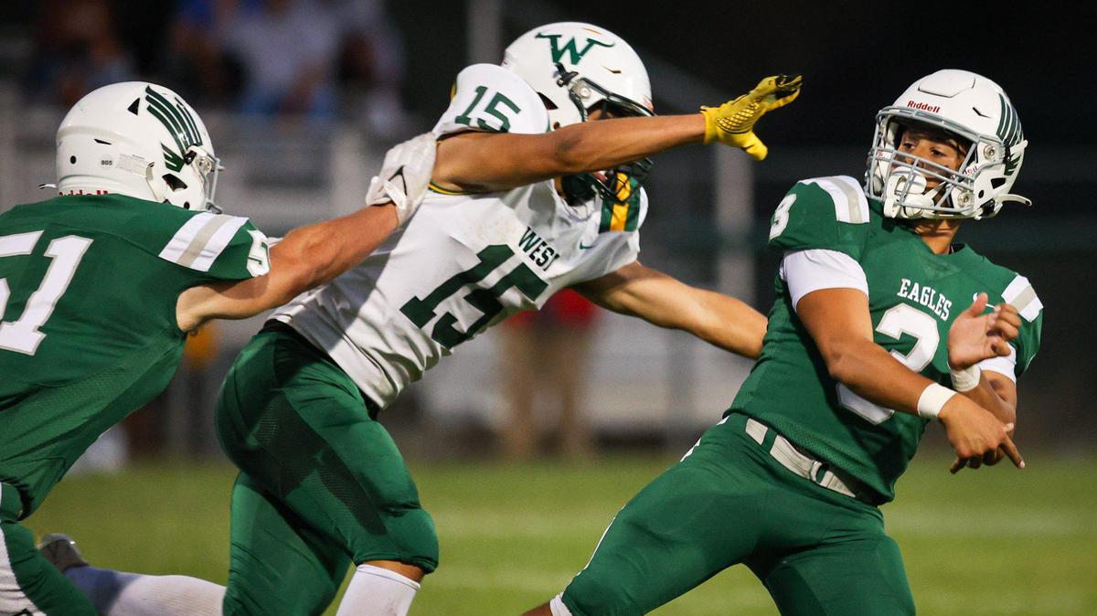 Anthony Chavez completes a touchdown pass under pressure from Guy Vasquez. Templeton beat West (Bakersfield) 42-0 in a high school football game Sept. 15, 2023.