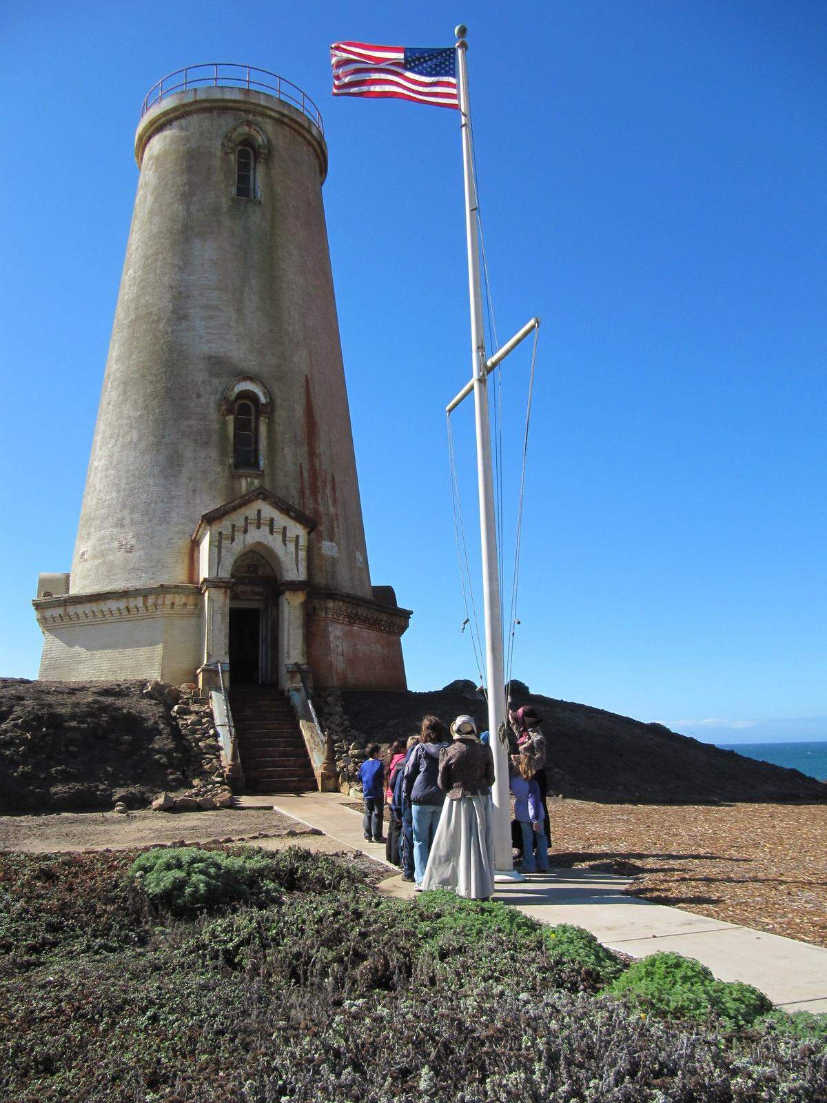 Visitors and costumed docents experience the 1875 Piedras Blancas Lighthouse on a 2010 tour. After the light station has been closed to the public for nearly a year, due to COVID-19 precautions, tours have resumed on a limited, once-a-week basis on Saturdays.