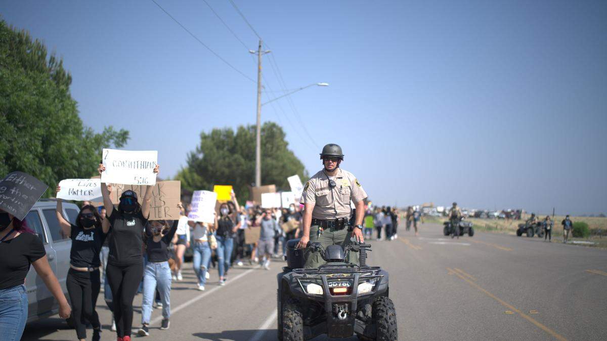 SLO sheriff’s deputies on quads and bicycles escorted marchers through Old Town Nipomo on Thursday. Threats against the protest had been posted on social media, but the event ended without incident.