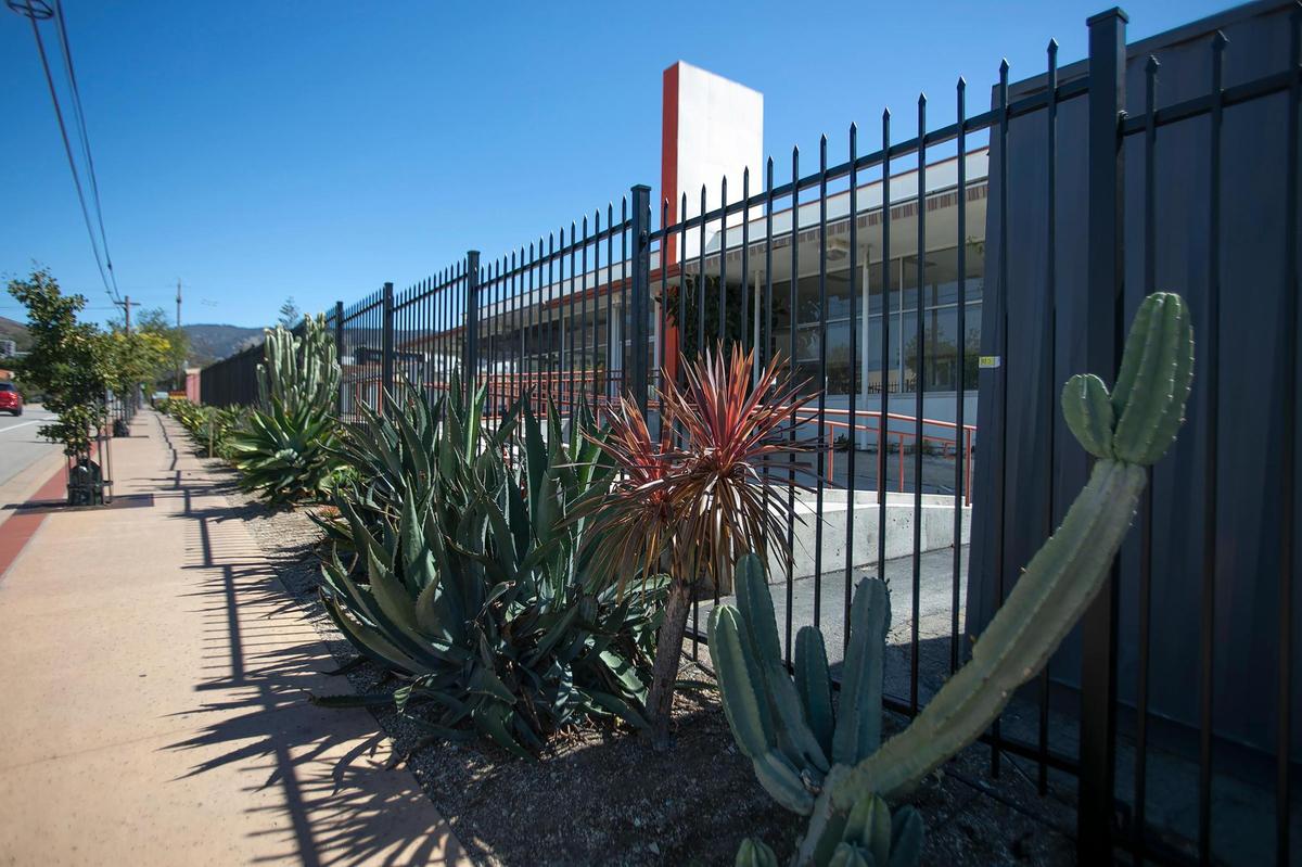 A group of local businesses is developing a new entertainment venue in San Luis Obispo called The Hub, at the former Daylight Home and Patio site on Monterey Street. The group recently repainted the previously bright orange fencing around the property as part of the development.