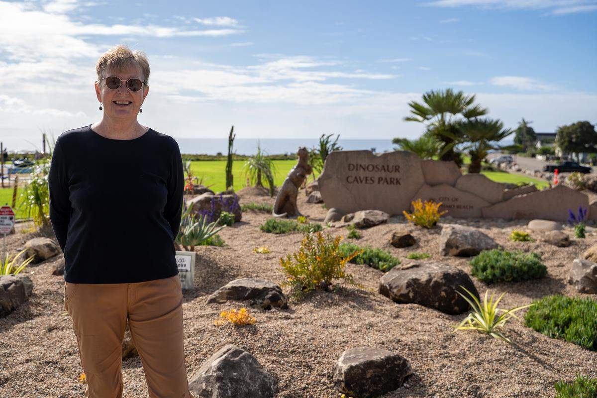 Retired veterinarian and Central Coast Cactus and Succulent Society member Maggie Wagner stands in front of The Garden at Dinosaur Caves, a garden she helped create, on Tuesday, Nov. 18, 2025. The park will hold an official ribbon-cutting on Dec. 12 to celebrate its opening. Wagner is facing a terminal cancer diagnosis and was looking for a way to leave a lasting legacy in Pismo Beach.
