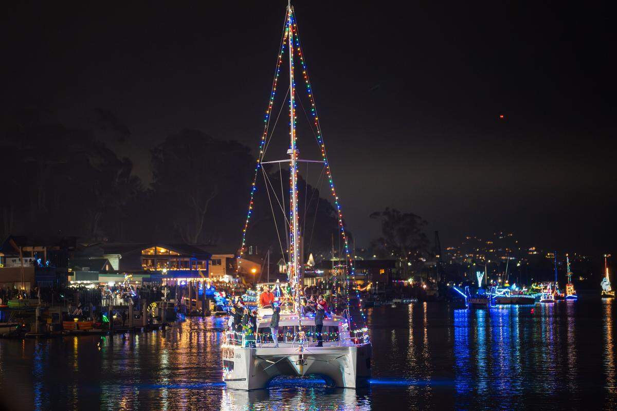 A tall sailboat decked out in festive lights arrives for the Morro Bay Lighted Boat Parade on Saturday, Dec. 13, 2025. The parade drew thousands of onlookers and dozens of boats equipped with festive lighting.