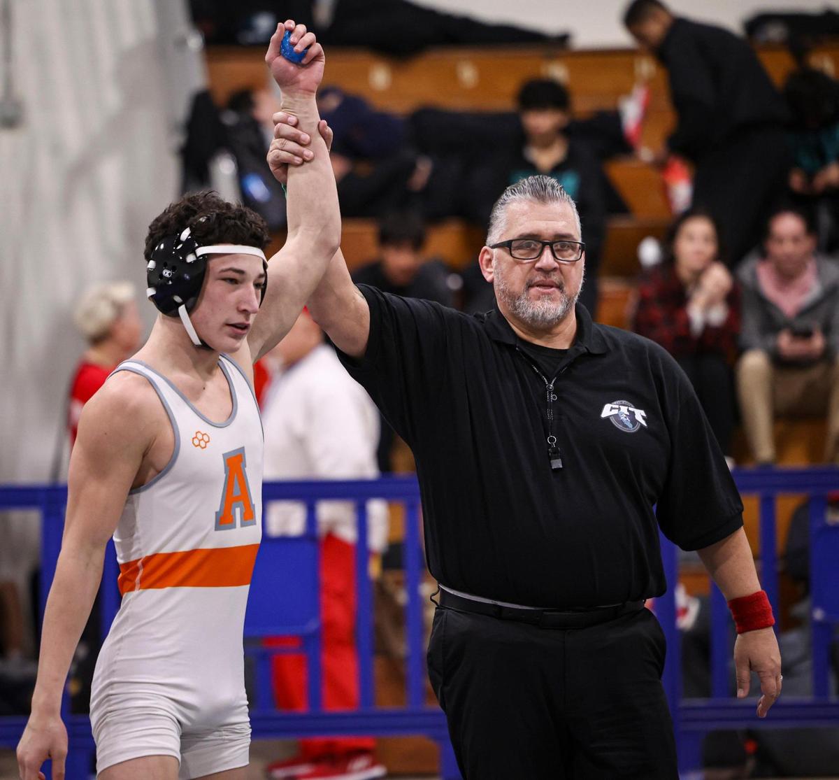 Kaden Pryor of Atascadero is declared winner in the first-round 138-pound bout by referee Marcelino Maytorena. The referee won the championship at this tournament in 1987 over an opponent from Atascadero. Over 900 wrestlers from across California came to Morro Bay to attend the California Invitational Tournament on Jan. 19, 2024.