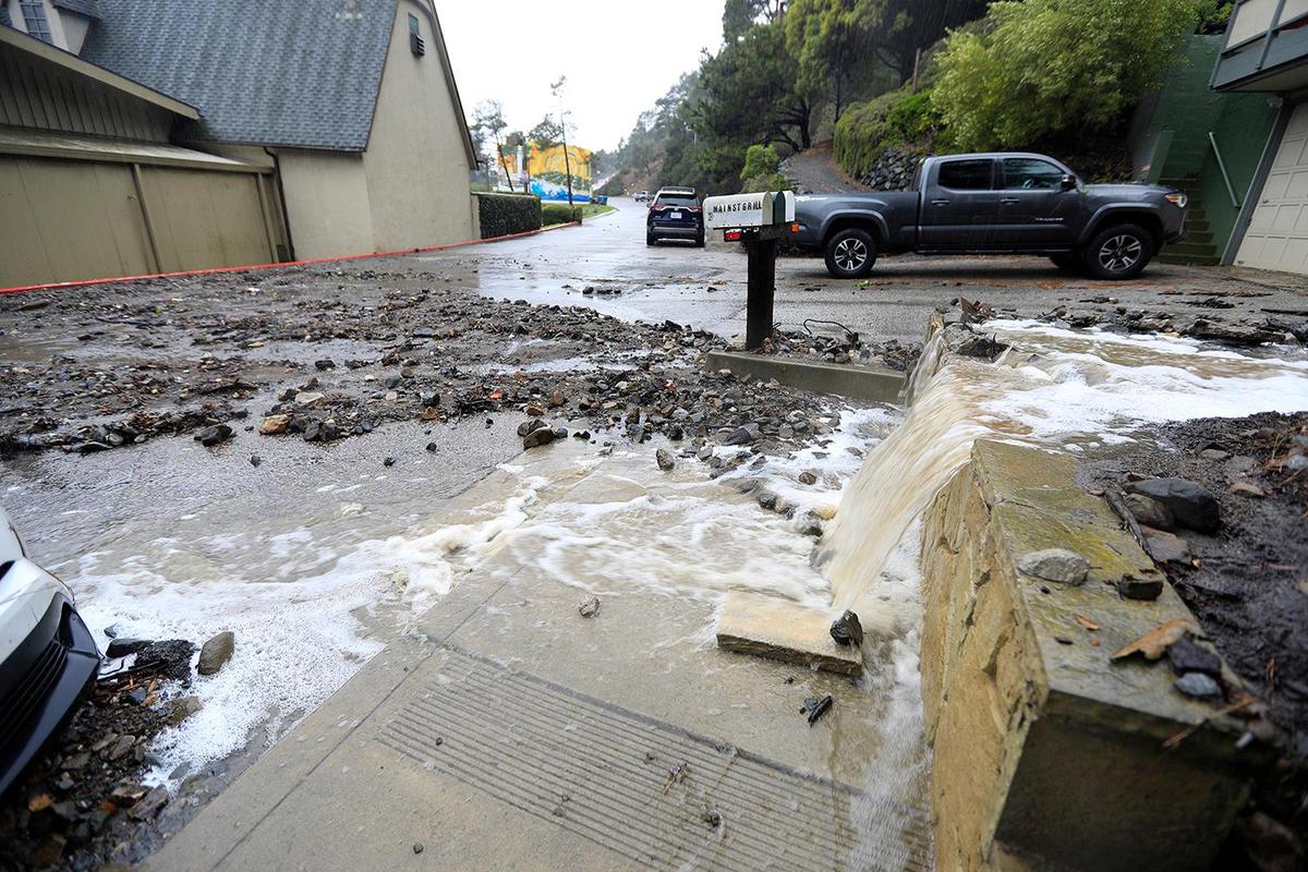 A strong storm hit the North Coast area with heavy rain and high winds on Wednesday, Jan. 27, 2021. Water and rocks flow off the hill onto Kent Street, behind the Shell Station in Cambria. The Shell Station was flooded with mud and water.