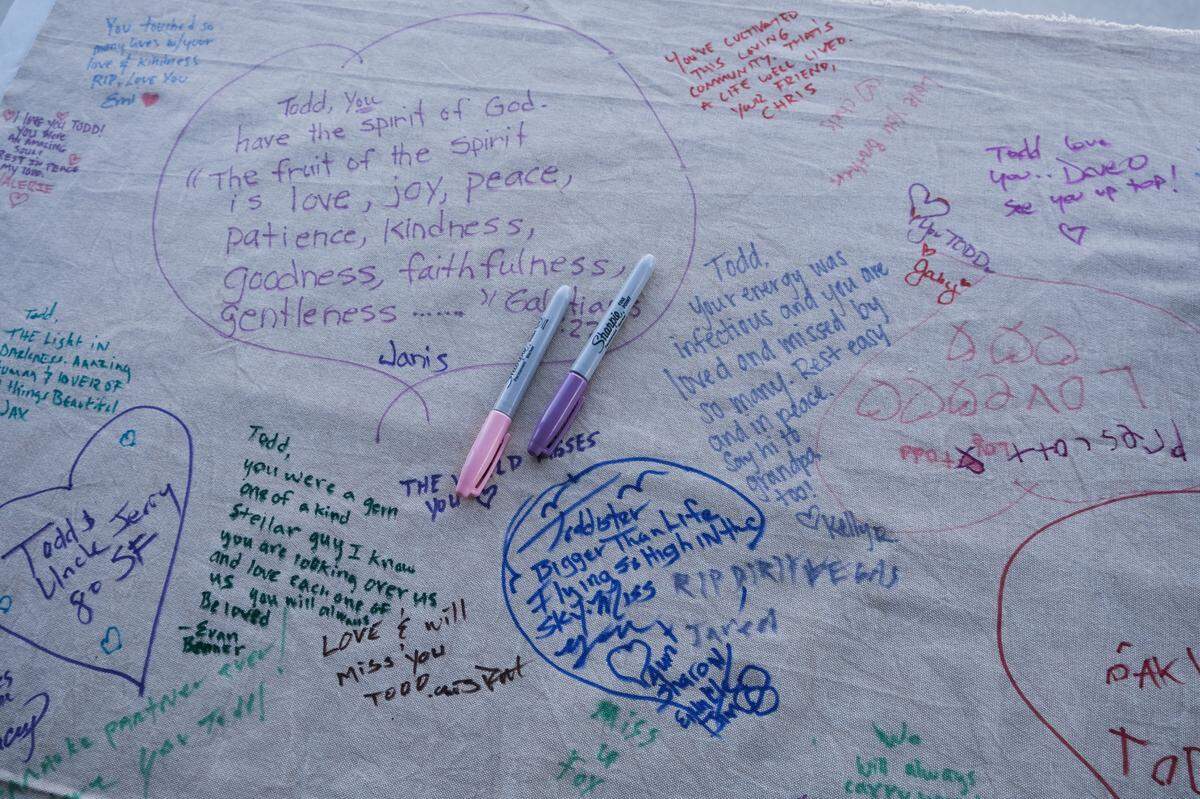People wrote messages for Todd Pinion on a tablecloth at his memorial in Santa Margarita on Nov. 9, 2024. Pinion was killed in an alleged hate crime on Oct. 23, 2024.