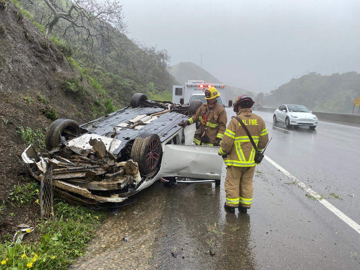 Cal Fire firefighters respond to the scene of a vehicle rollover crash on northbound Highway 101 on the Cuesta Grade on Tuesday, March 14, 2023.
