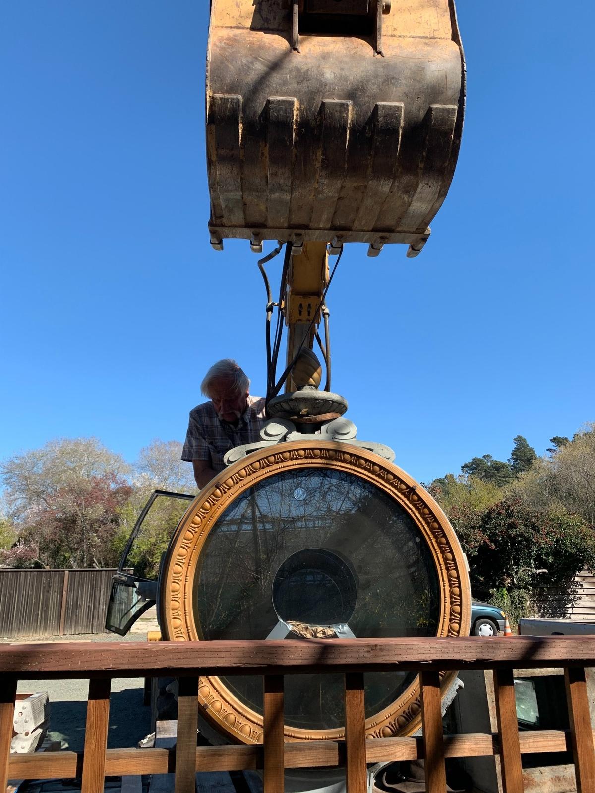 Billy Thomas of Morro Bay (shown above) and Josh Warren of Cambria attached the West Village town clock to a flatbed trailer for shipping. Sue Foreman — who owns the Once Upon a Tyme clock-and-doll shop/museum adjacent to the historic timepiece standing guard nearby — recently sold the massive town clock that was nicknamed “Big Time.”