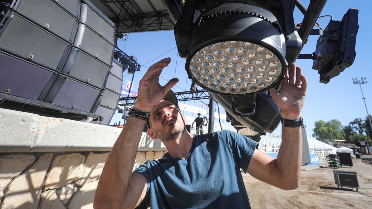 Josh Deems checks the movement on lights before they are lifted into place at the Chumash Main Grandstand Arena on Monday, July, 15, 2024, ahead of the California Mid-State Fair’s opening on Wednesday.