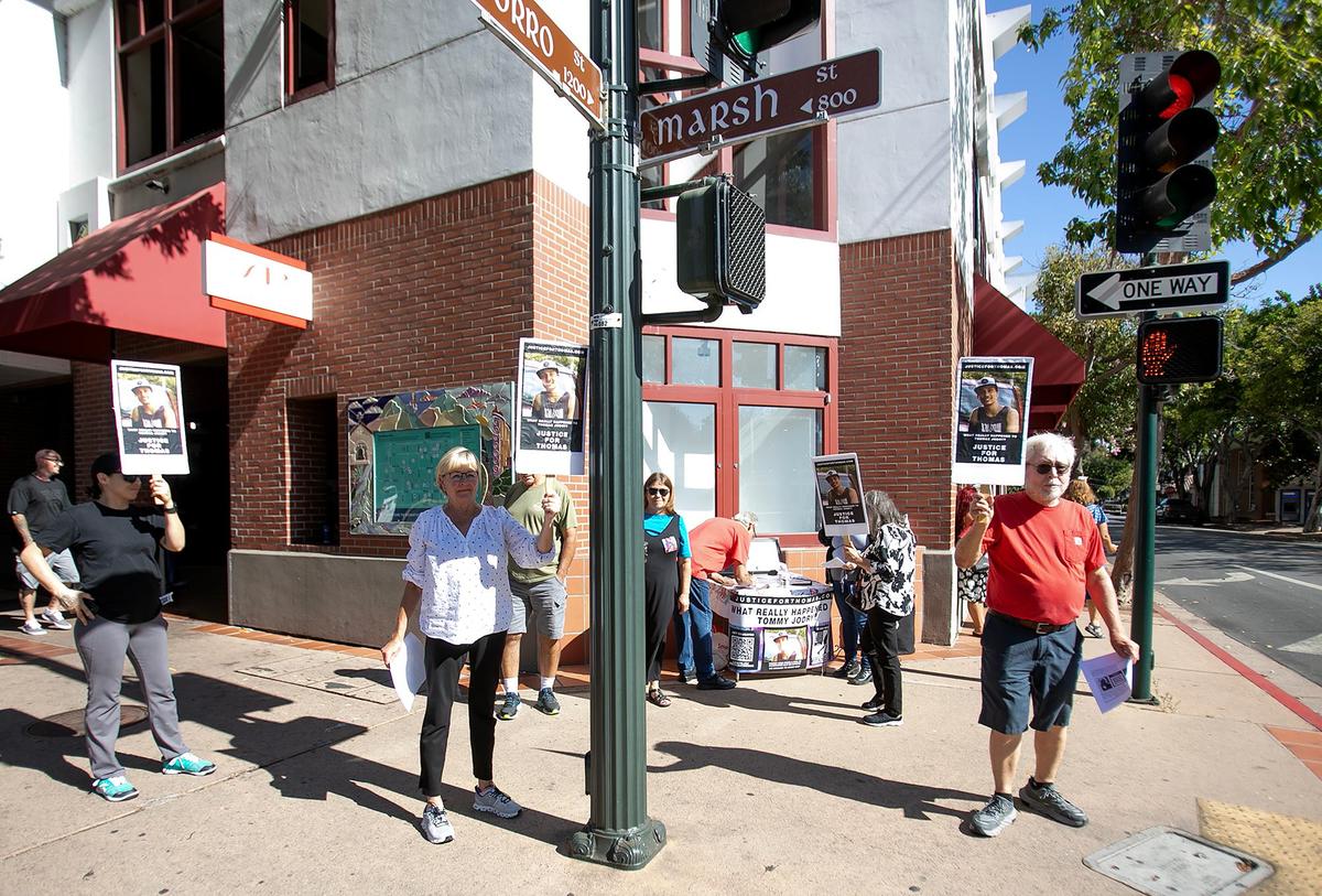 Bill and Mary Jodry held a vigil on Sept. 14, 2024, to honor their son Thomas Jodry, who died in a fall from the parking garage on Marsh Street in San Luis Obispo, on the anniversary of his death. Elaine Jacobs of Shell Beach and Wayne Peterson of Templeton hold up signs in support.