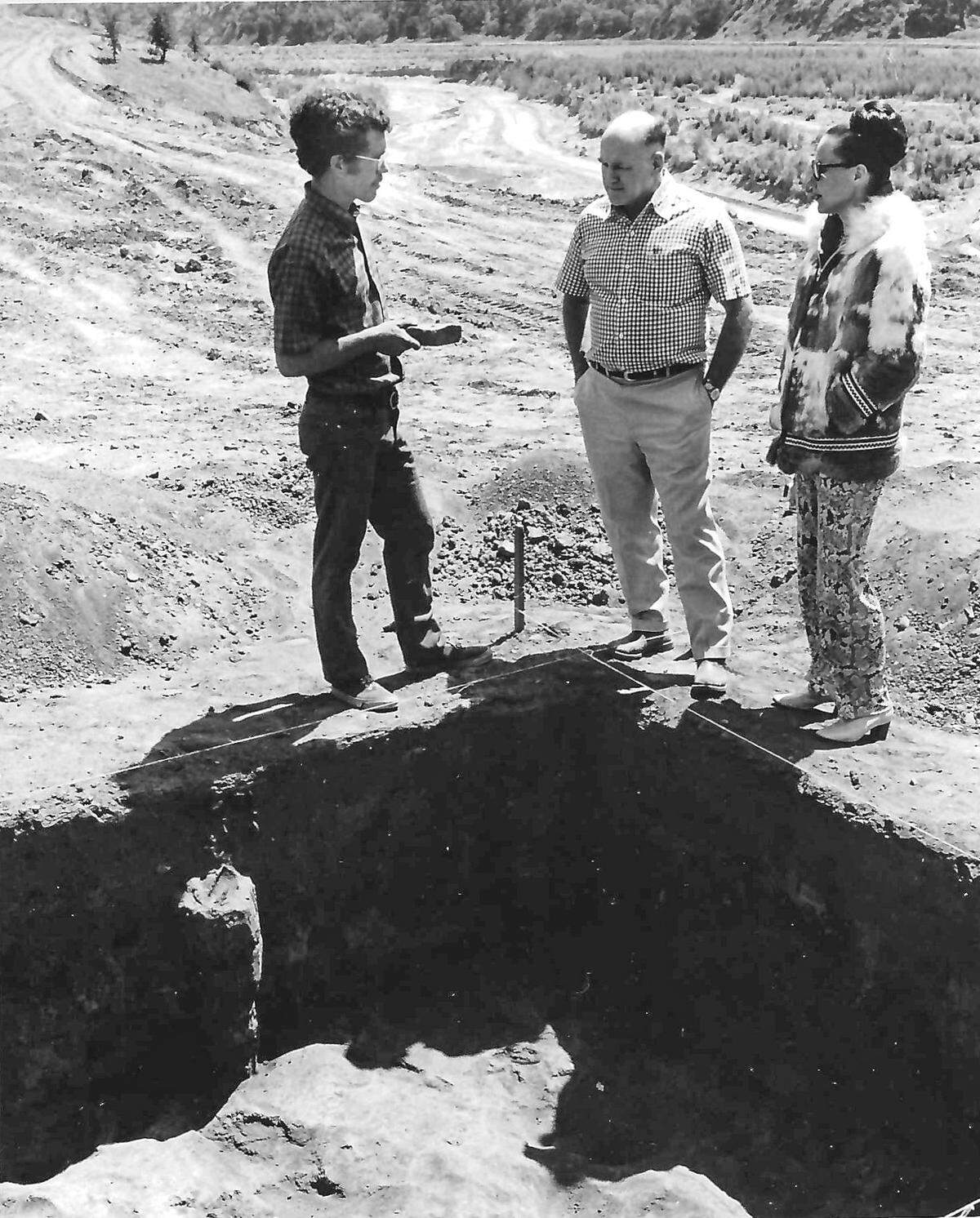 Max Farrar, a member of the archeological party, shows a Chumash artifact to Alex and Phyllis Madonna at one of the sites being excavated by a Costa Mesa organization. Story published May 22, 1971, on the construction of Highway 166.
