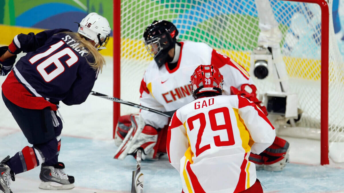 Kelli Stack (16) of the U.S. scores against China's Yao Shi (30).  The U.S. won 12-1. (Harry E. Walker / MCT)