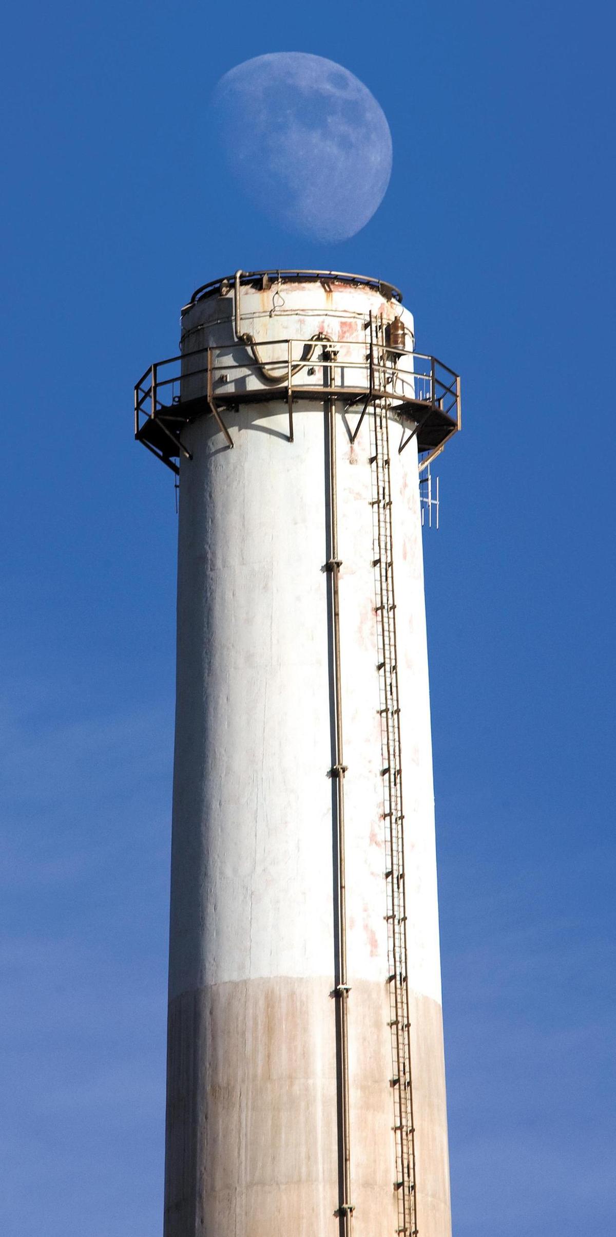 The moon rises above one of the 450 foot tall power plant smoke stacks in Morro Bay in 2011.