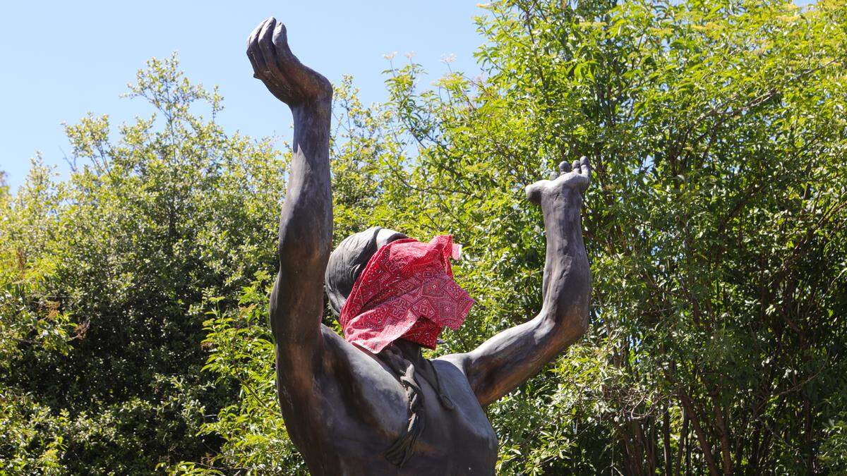 A bandanna mask covers the face of the “Oh Great Spirit” sculpture in San Luis Obispo in April 2020. The 2011 sculpture by artist Nell Banister Scruggs stands next to the corner of Prado Road and South Higuera Street.