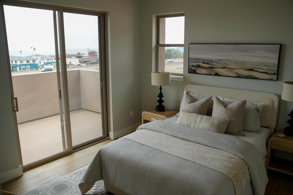 A bedroom in one of the homes at Barcelona Point, a new luxury home development in Pismo Beach, looks out over Highway 101, pictured here Tuesday, July 1, 2025. The development is nestled into the base of the mountains that border Pismo Beach to the east and bordered by Mattie Road and Highway 101 to the west.