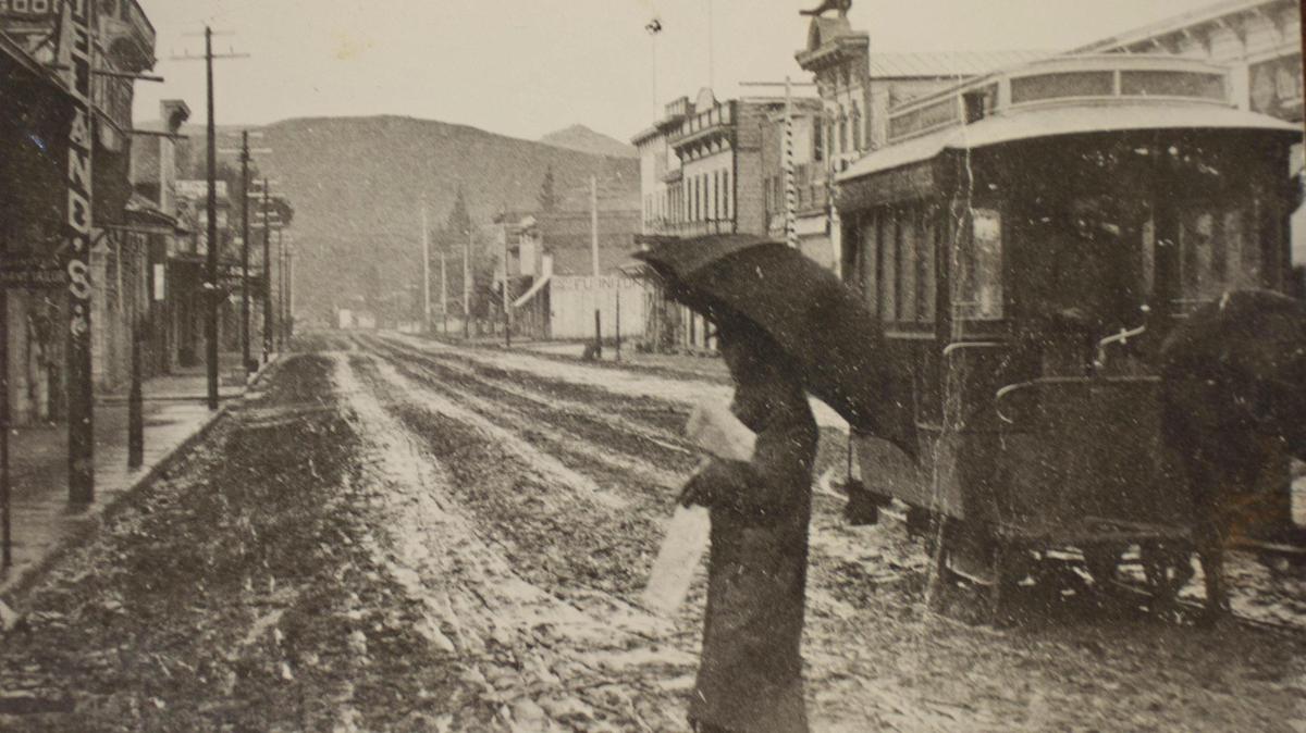 This scene south on Higuera Street at about Chorro Street distributed by the Morning Tribune in postcard size to its readers on Jan 1, 1890. San Luis Street Railway pulled by horse is at right while carrier makes his way across a mud street. The Tribune, and all other newspapers published here in earlier years, frequently complained about the mud in winter and the dust in summer.