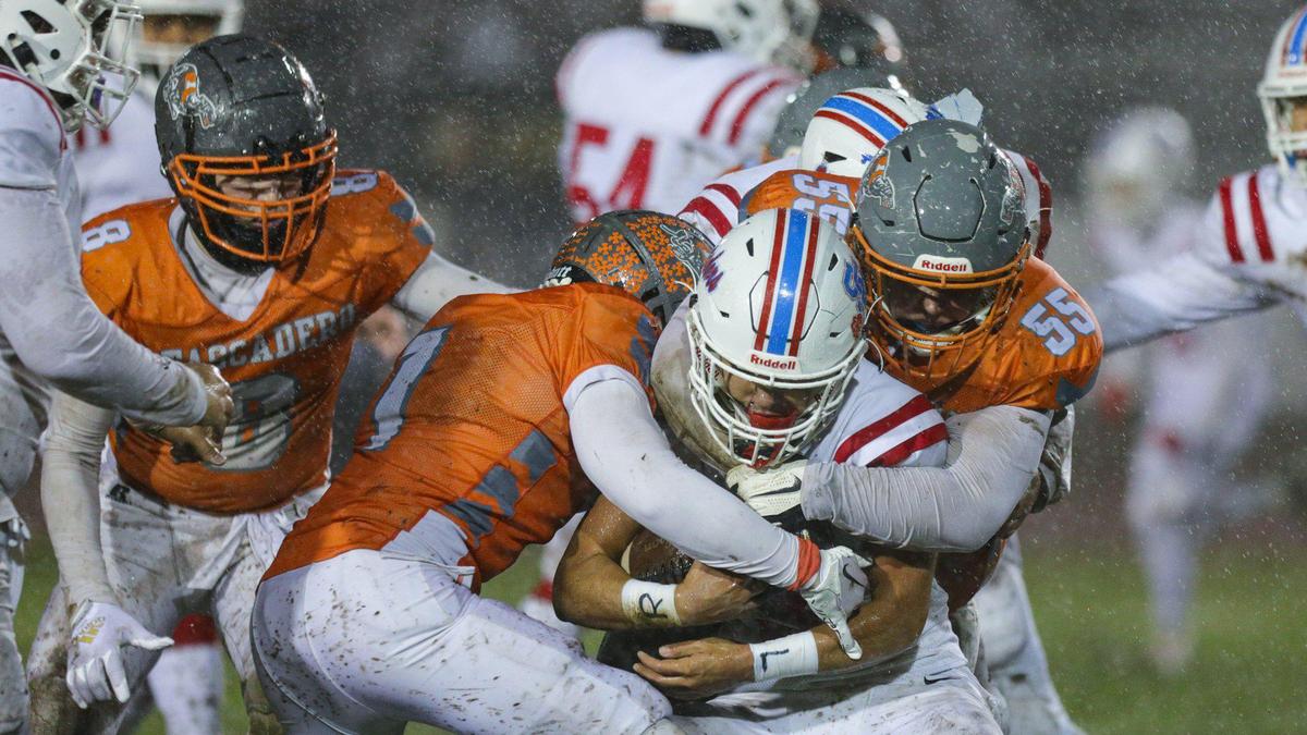 The Atascadero defense wraps up the San Gabriel ball carrier. The Atascadero Greyhounds beat the San Gabriel Matadors 41-0 to win the CIF Division 6-A State Championship football game on Dec. 10, 2022.