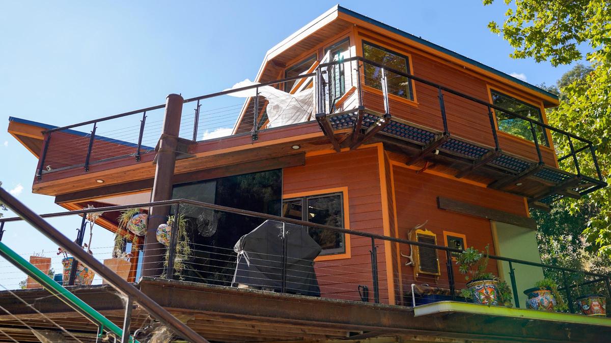 Longtime former San Luis Obispo County resident Reggie Whibley’s home north of Lopez Lake is a treehouse-like structure built on metal legs painted to resemble trees Tuesday, Oct. 29, 2024. Following Whibley’s death in 2020, the property went up for sale, featuring views of the surrounding canyon, custom woodworking and design and a fully converted Beachcraft airplane parked in the backyard, which serves as the guest lodging.
