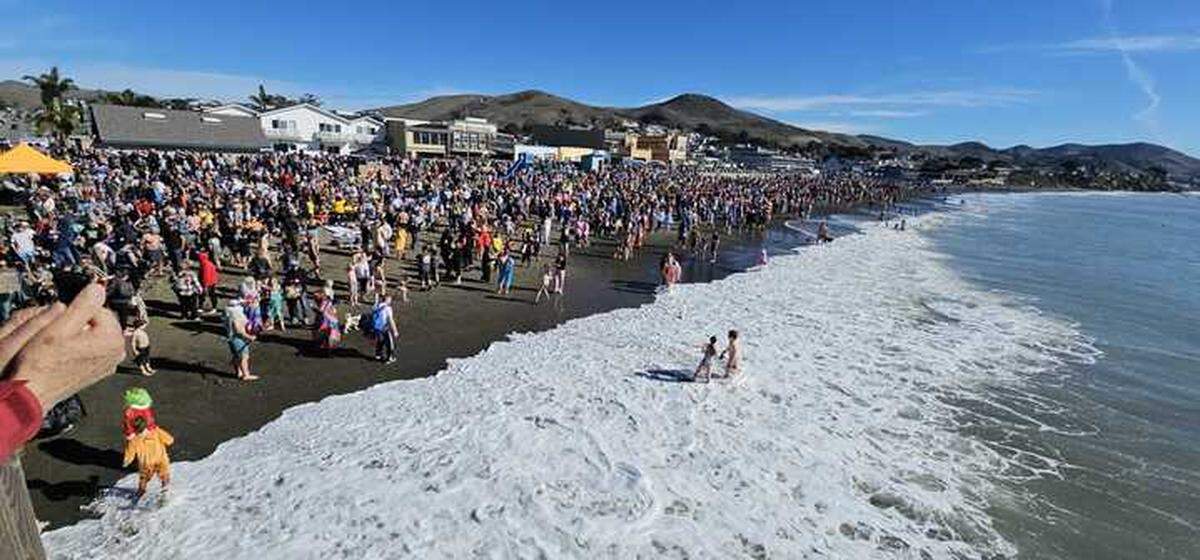 Hundreds of participants turned out for the 2025 Polar Bear Dip near Cayucos Pier, braving water temperatures in the low 50s.
