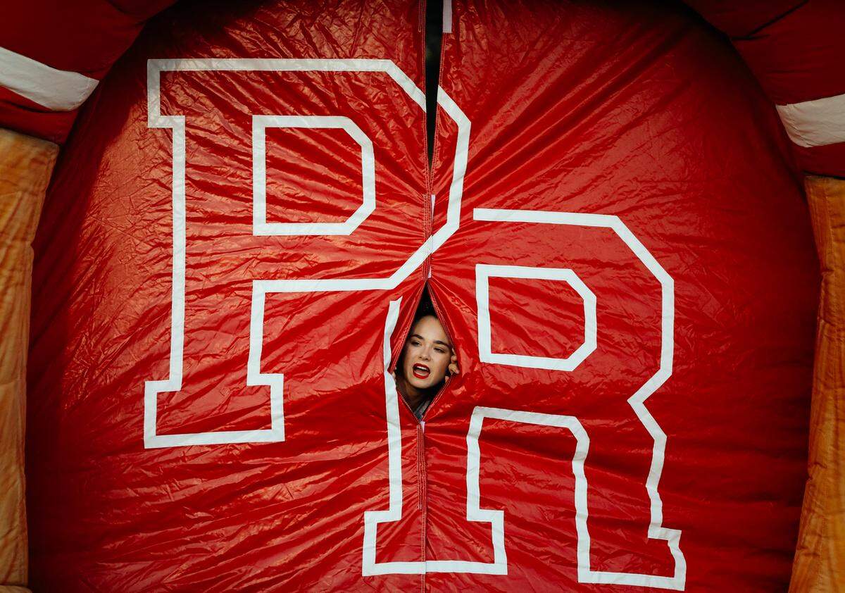 A cheerleader peeks out from inside the entry tunnel for the Paso Robles High School football team before their game against Fresno’s Central High School. The image was an award winner in the sports feature photo category of the 2018 California Journalism Awards.