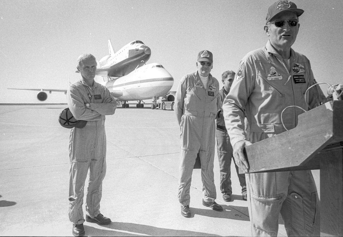 Pilot Fitzhugh L. Fulton Jr. stands a podium while the rest fo the 747 crew listens. The brand new space shuttle Discovery visited Vandenberg Air Force Base on Nov. 6, 1983.