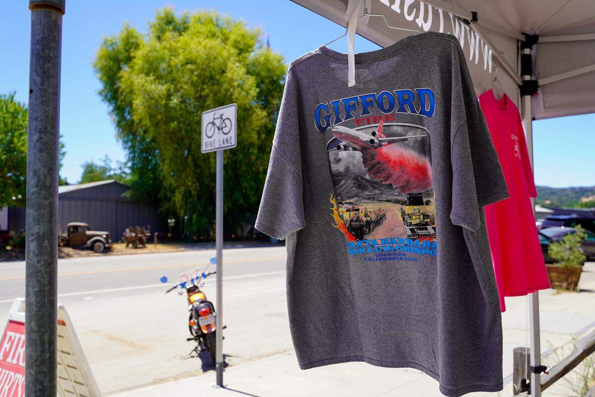 Gifford Fire merchandise hangs in a booth set up in downtown Santa Margarita on Wednesday, Aug. 13, 2025.