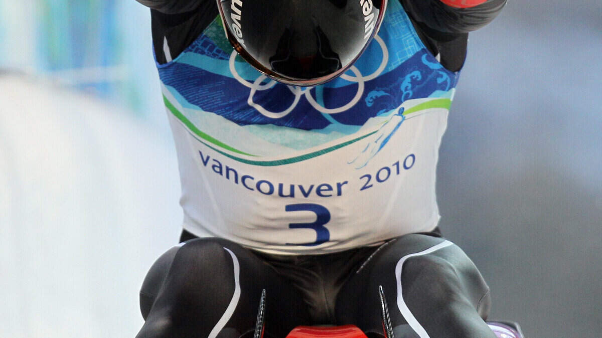 Felix Loch of Germany celebrates his gold medal finish during the final run of the men's singles luge competition. (AP Photo/Ricardo Mazalan)