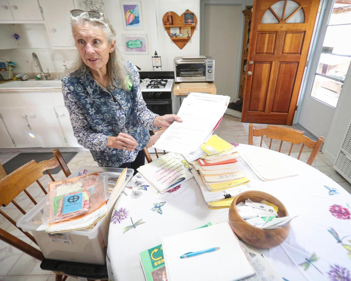 Dawn Marie Anderson has boxes of paperwork related to her son, seen here on Sept. 3, 2024. He has struggled with schizoaffective disorder and been in treatment or jail for over the last decade.