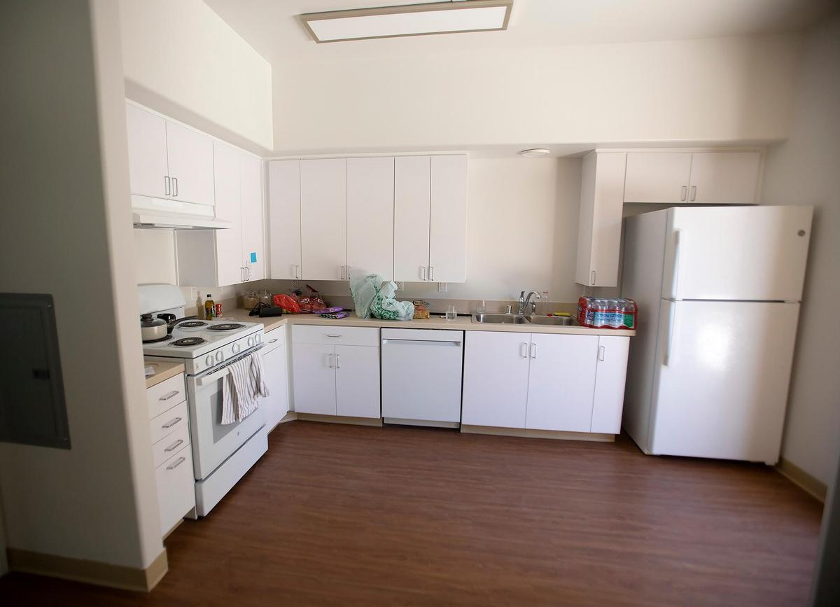 Denise Flores, who was homeless for five years until 2022, recently obtained housing in Templeton in a new senior complex. Flores is slowly stocking her brand new kitchen.