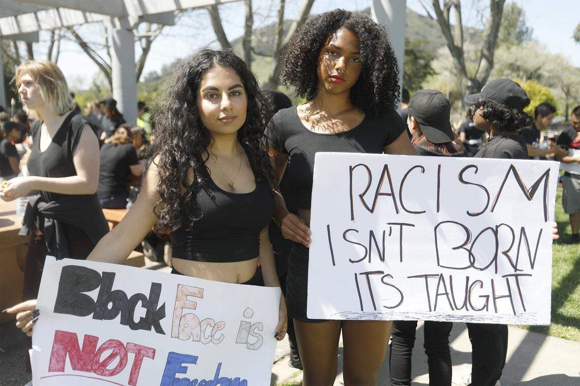 In this April 15, 2018, file photo, Cal Poly student Ariana Afshar, left, and Cuesta College student Tianna Arata, right, participate in a march to protest racist incidents on the Cal Poly campus. Some student organizations are calling for a mandatory ethnic studies class for all students.