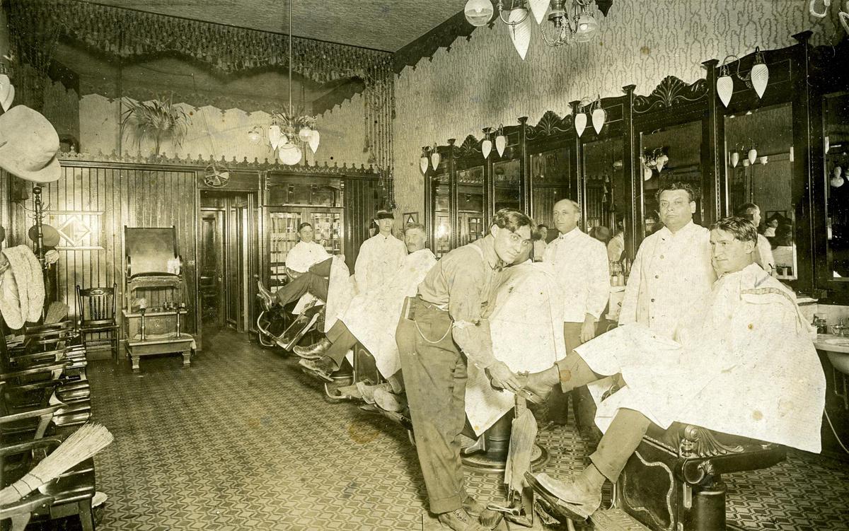 This interior shot of an old San Luis Obispo landmark was taken sometime between 1912 and 1913. John Fourcade is the bootblack putting a high gloss on Louie Angellini’s shoes. Joe Rodrigues is the first barber, Oscar Lusi is the second barber and V. Johnson is the third barber. The fourth barber is unidentified. The picture comes from Mrs. Olive Fourcade.