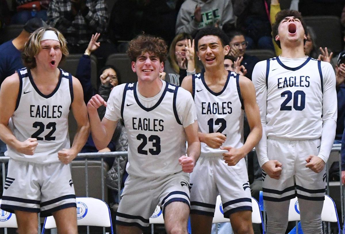 The Arroyo Grande bench celebrates another 3-point shot against Porterville in its 59-30 win at the CIF Central Section basketball championships Friday, Feb. 24, 2023, in Fresno.