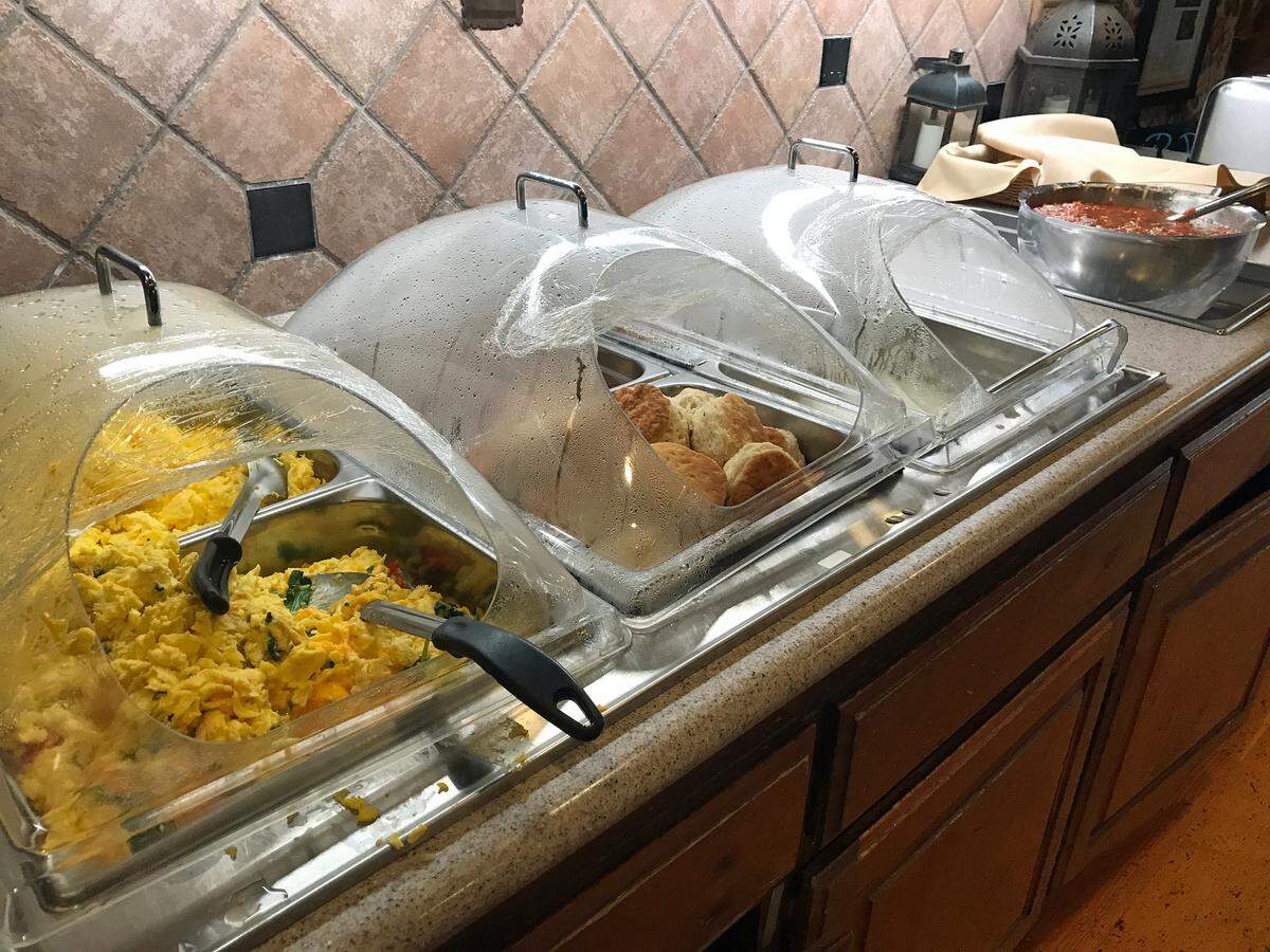 Scrambled eggs prepared two ways, hot biscuits and gravy, fat sausage links, home fries and muffins were on the ‘hot line’ Jan. 8 in the complimentary breakfast buffet provided to hotel guests at the Cambria Pines Lodge.